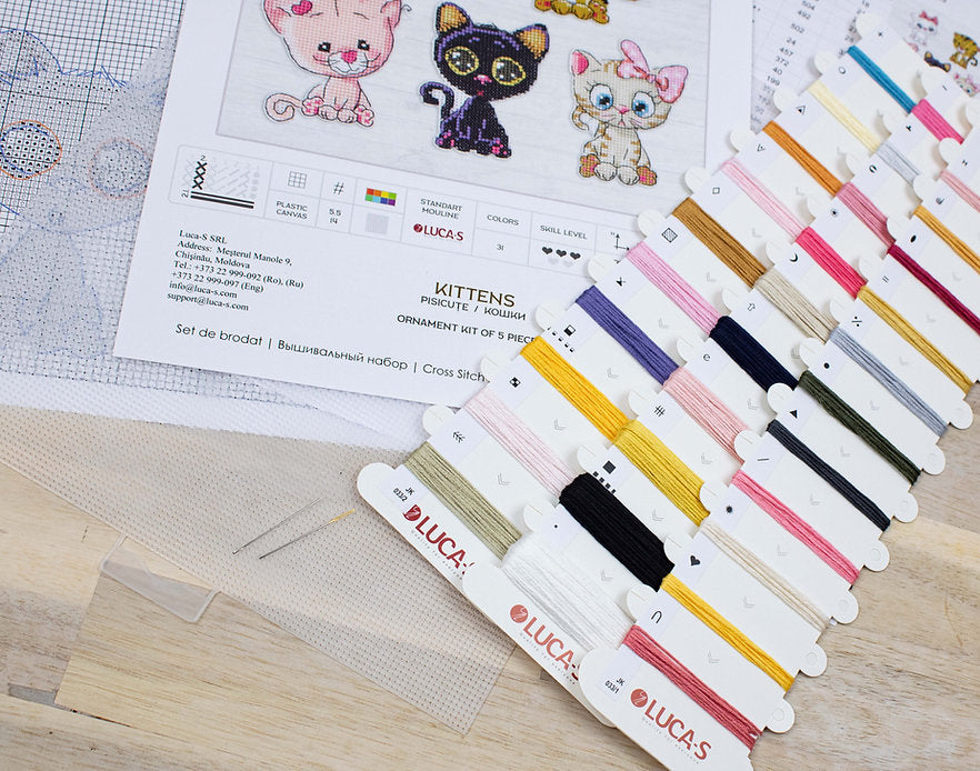 Kittens JK033L Counted Cross-Stitch Kit featuring colorful threads, Aida canvas, and a needle for crafting.