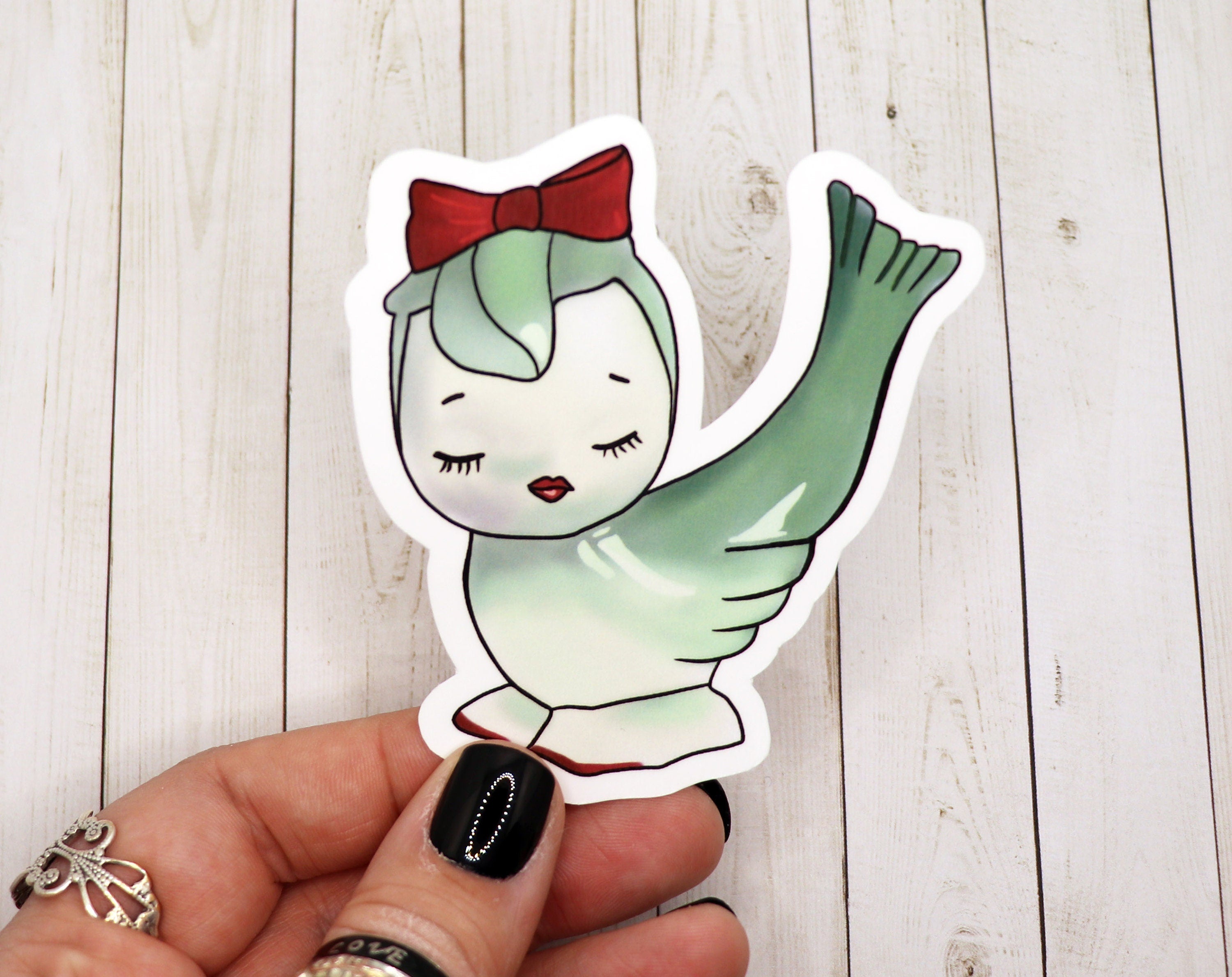 A colorful Kitsch Bird Sticker featuring a whimsical bird design on matte vinyl, perfect for personalizing various items.