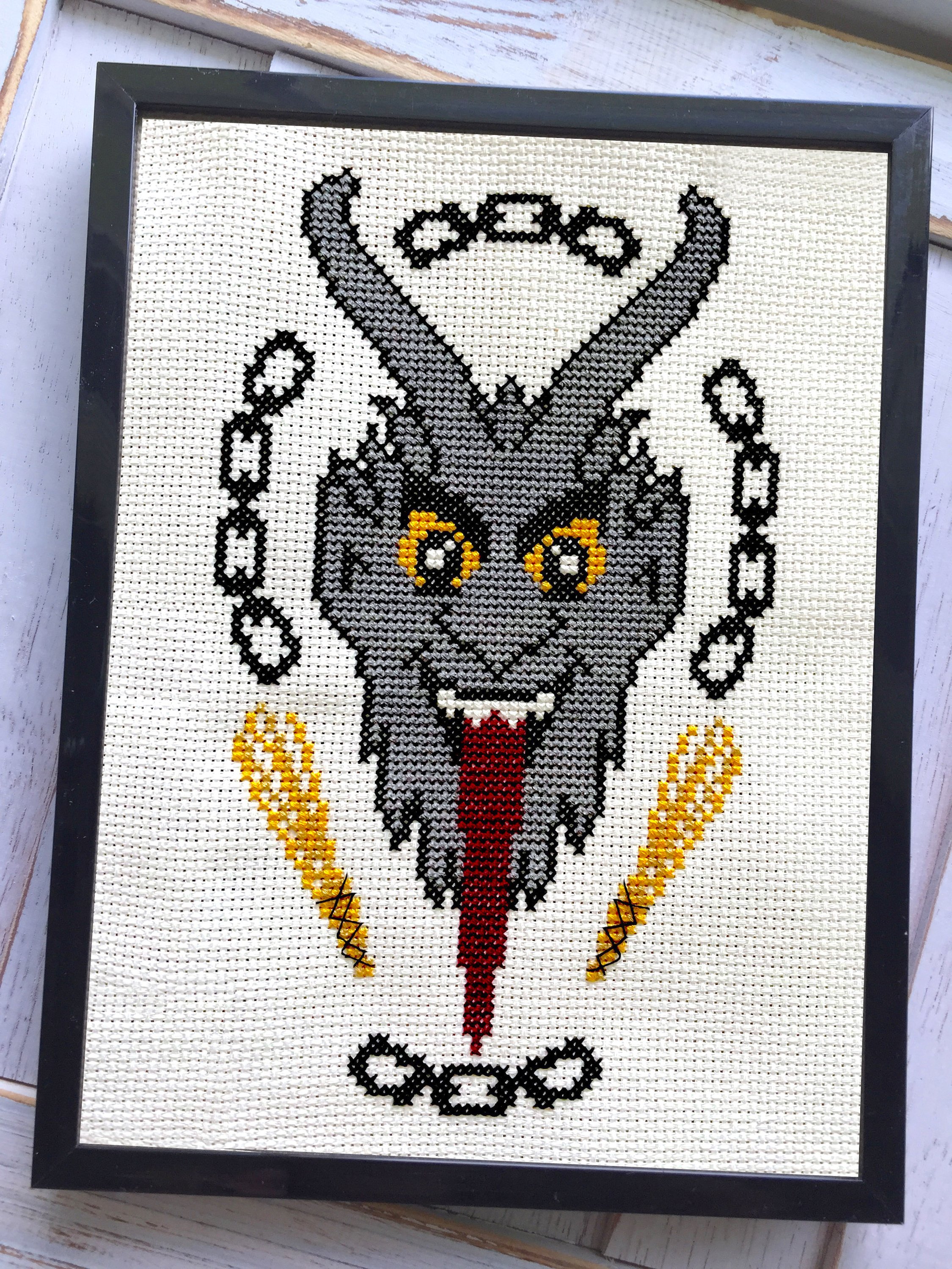 Krampus Counted Cross Stitch DIY Kit with supplies including fabric, threads, and hoop, showcasing a festive design.
