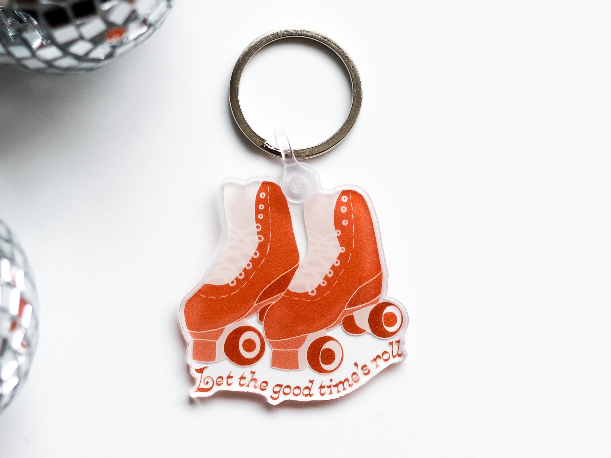 A colorful acrylic keychain featuring a retro roller skate design, perfect for organizing keys.