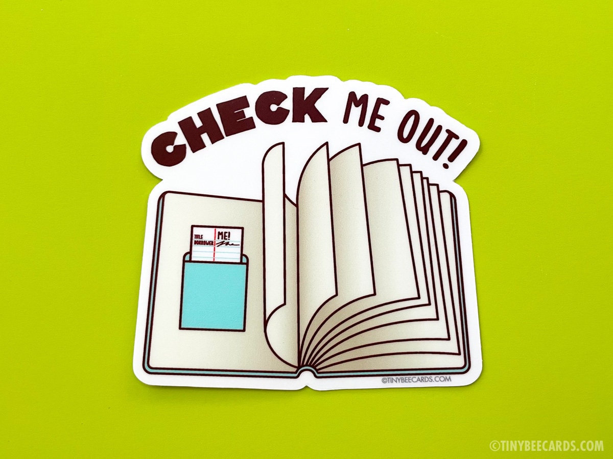 Vinyl sticker featuring the phrase 'Check Me Out!' designed for book lovers, showcasing a playful and colorful design.
