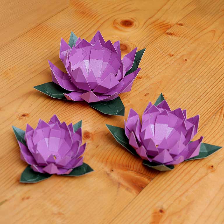Lotus Paper Craft Flower - Low Poly kit showcasing pre-cut and pre-folded pieces in vibrant colors, perfect for crafting enthusiasts.