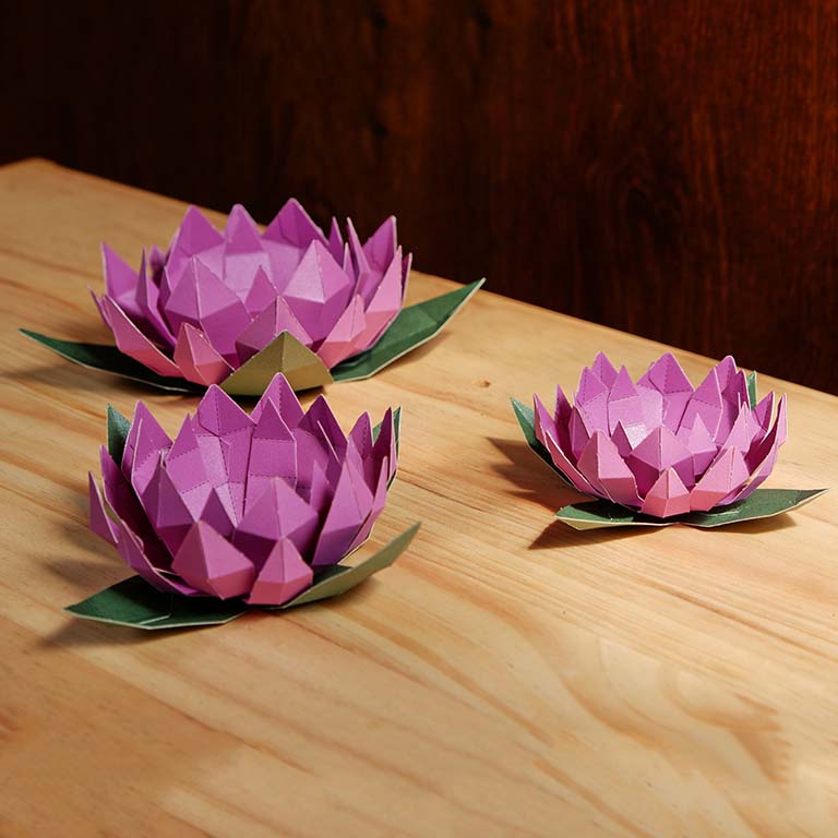 Lotus Paper Craft Flower - Low Poly kit showcasing pre-cut and pre-folded pieces in vibrant colors, perfect for crafting enthusiasts.