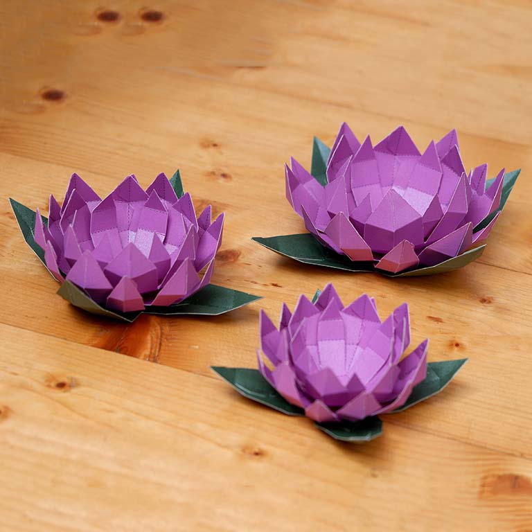Lotus Paper Craft Flower - Low Poly kit showcasing pre-cut and pre-folded pieces in vibrant colors, perfect for crafting enthusiasts.
