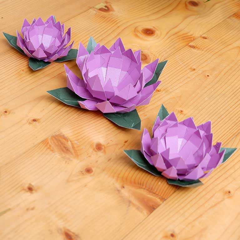 Lotus Paper Craft Flower - Low Poly kit showcasing pre-cut and pre-folded pieces in vibrant colors, perfect for crafting enthusiasts.