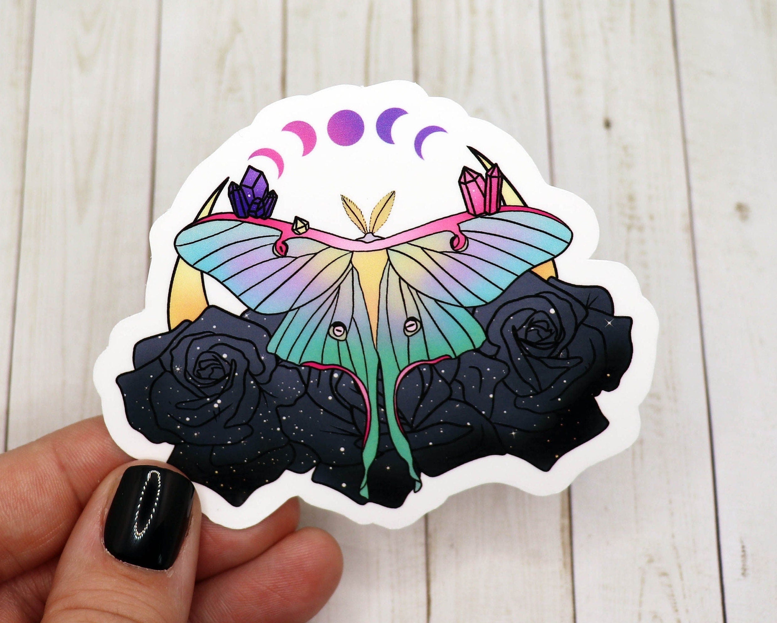A vibrant Luna Moth vinyl sticker on a white background, showcasing intricate details and colors.