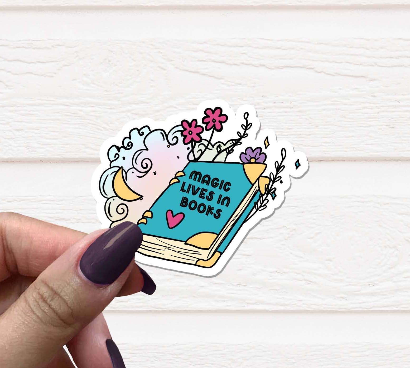 Magic Lives in Books Vinyl Sticker on a colorful background, showcasing its vibrant design and matte finish.