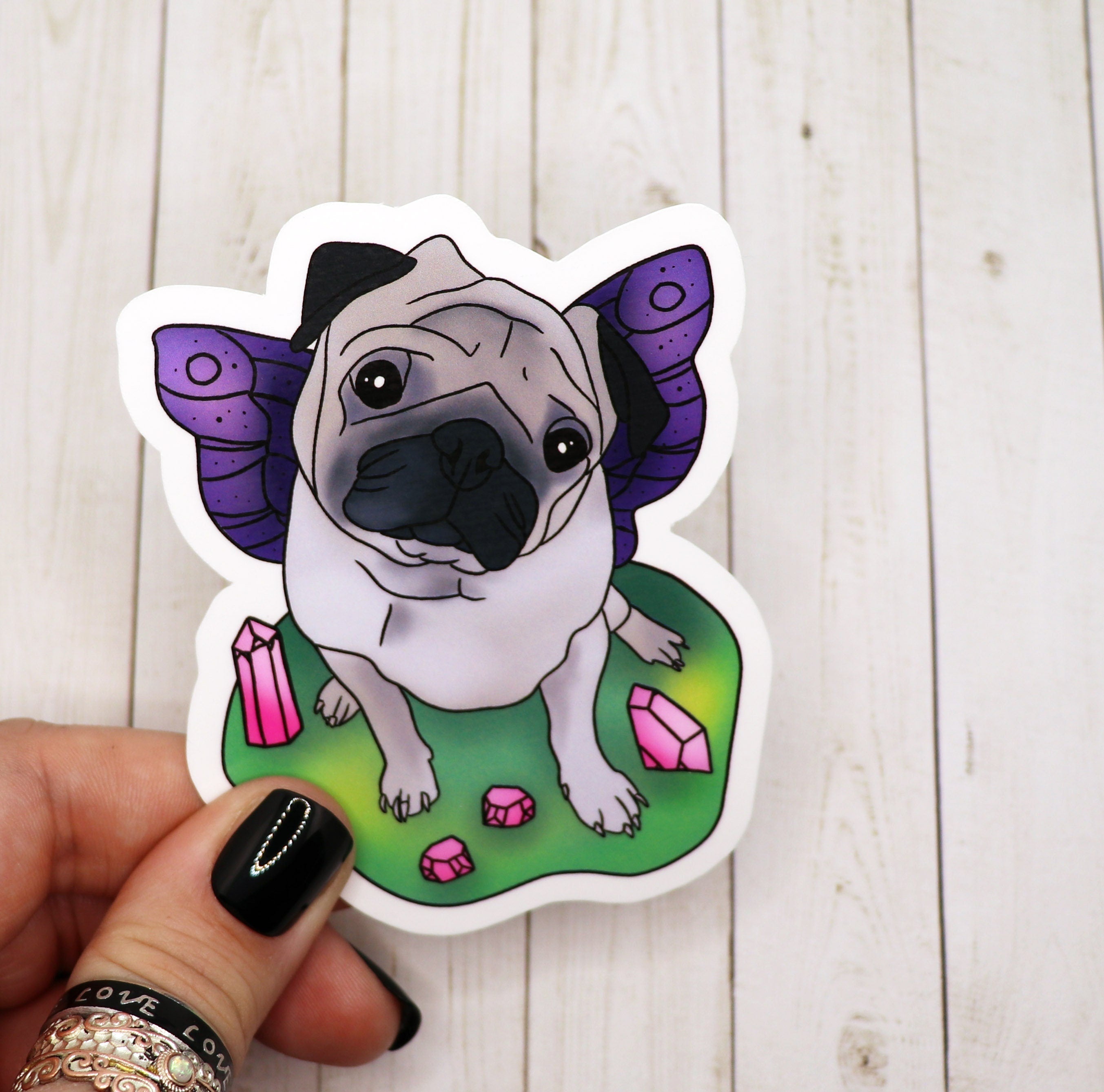 A colorful vinyl sticker featuring a whimsical pug fairy design, perfect for personalizing various items.