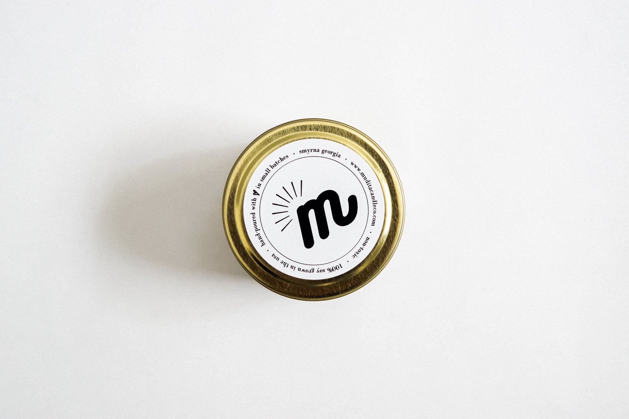 Merry & Lit candle in a 4oz jar, featuring a warm blend of cinnamon, fir needles, clove, and vanilla, designed for a cozy atmosphere.