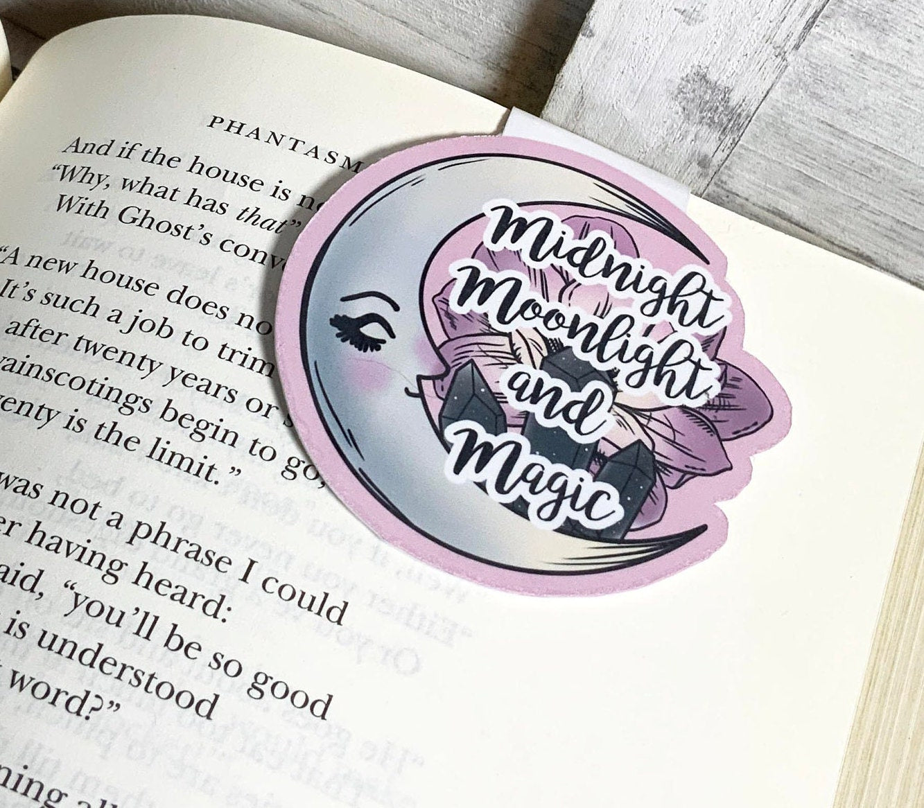 Midnight Moonlight and Magic Magnetic Bookmark featuring a moon design, measuring 2.5 inches square, with strong magnets for secure page holding.