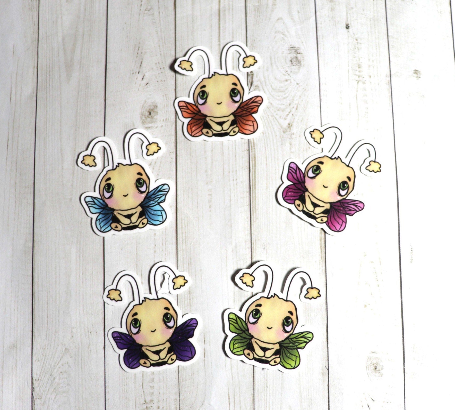 A colorful Mini Bee Sticker Pack featuring five unique bee designs on high-quality matte vinyl.