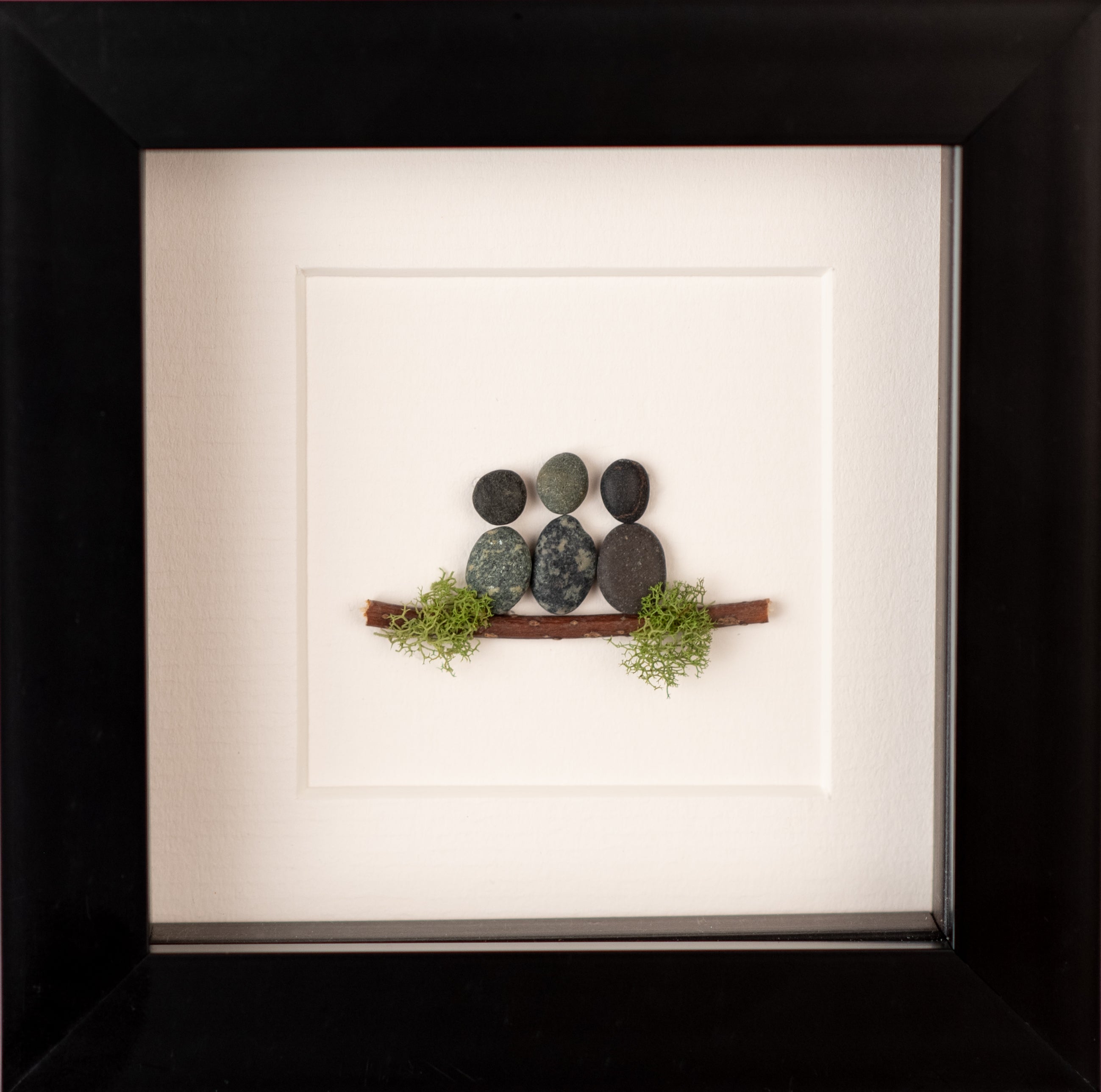 A beautifully crafted Mini Family of 4, showcasing unique designs made from natural materials, framed in black or white.