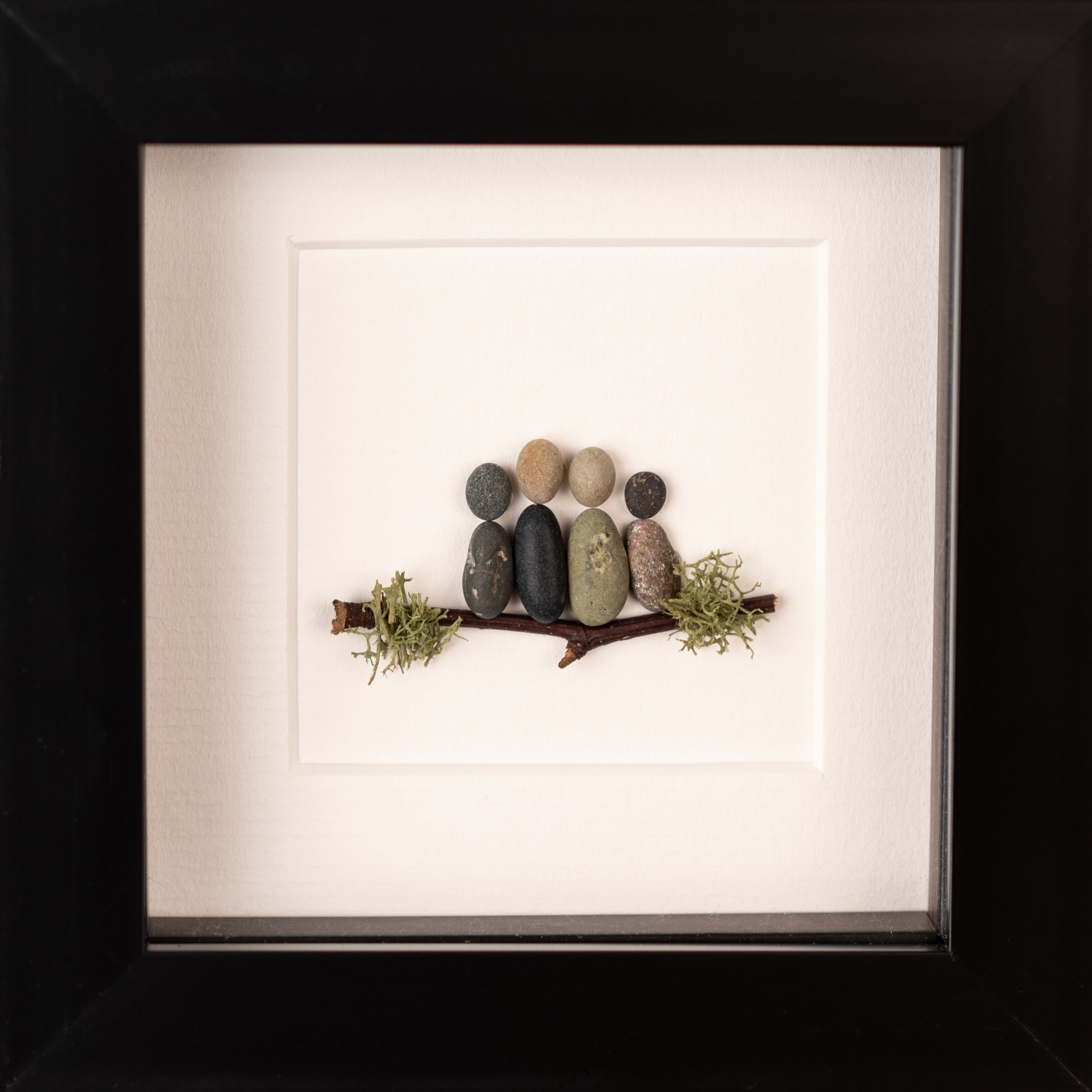 A beautifully crafted Mini Family of 4, showcasing unique designs made from natural materials, framed in black or white.