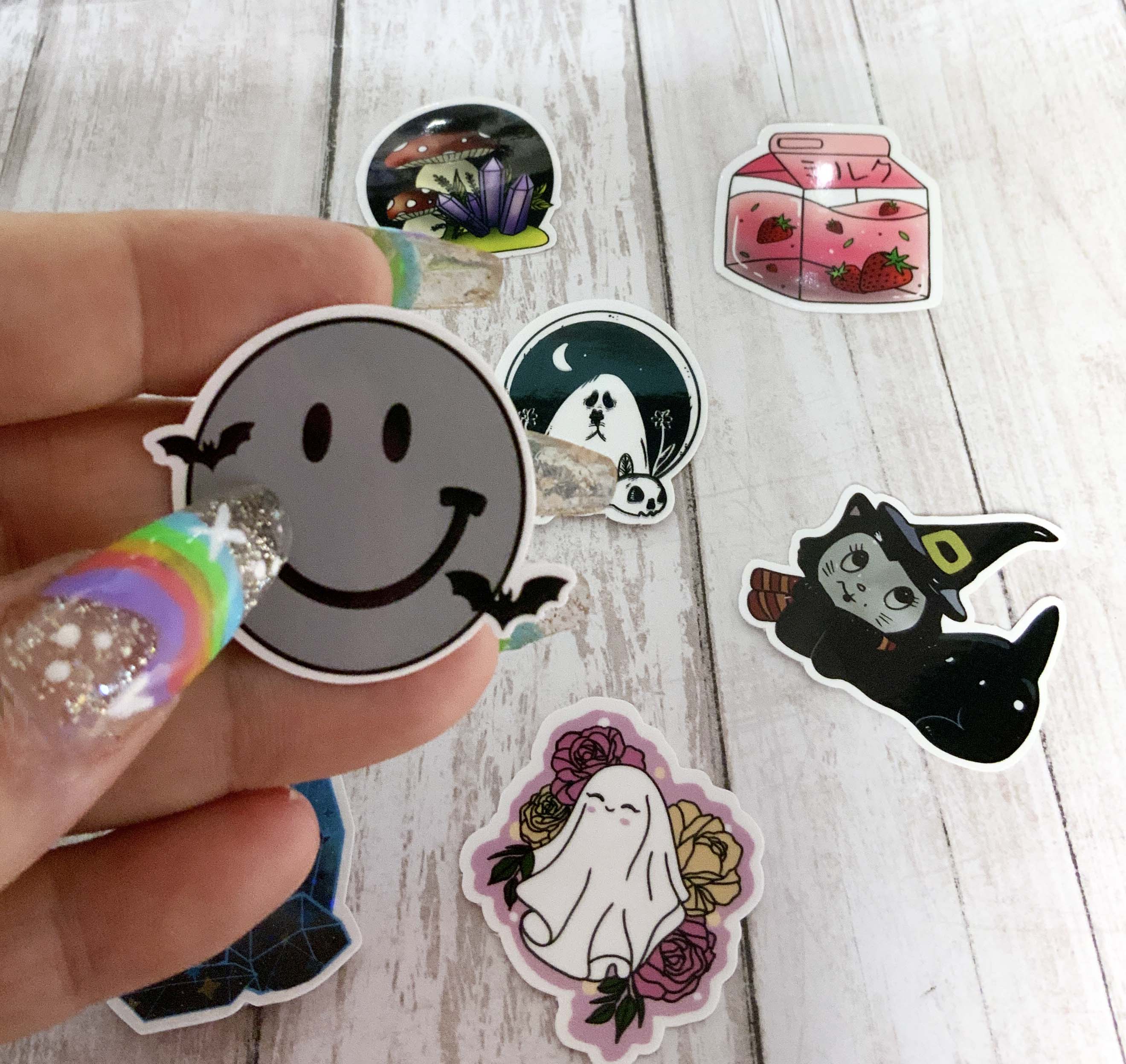 A colorful assortment of MINI Mystery Stickers featuring witchy, gothic, and cottagecore designs, displayed on a flat surface.