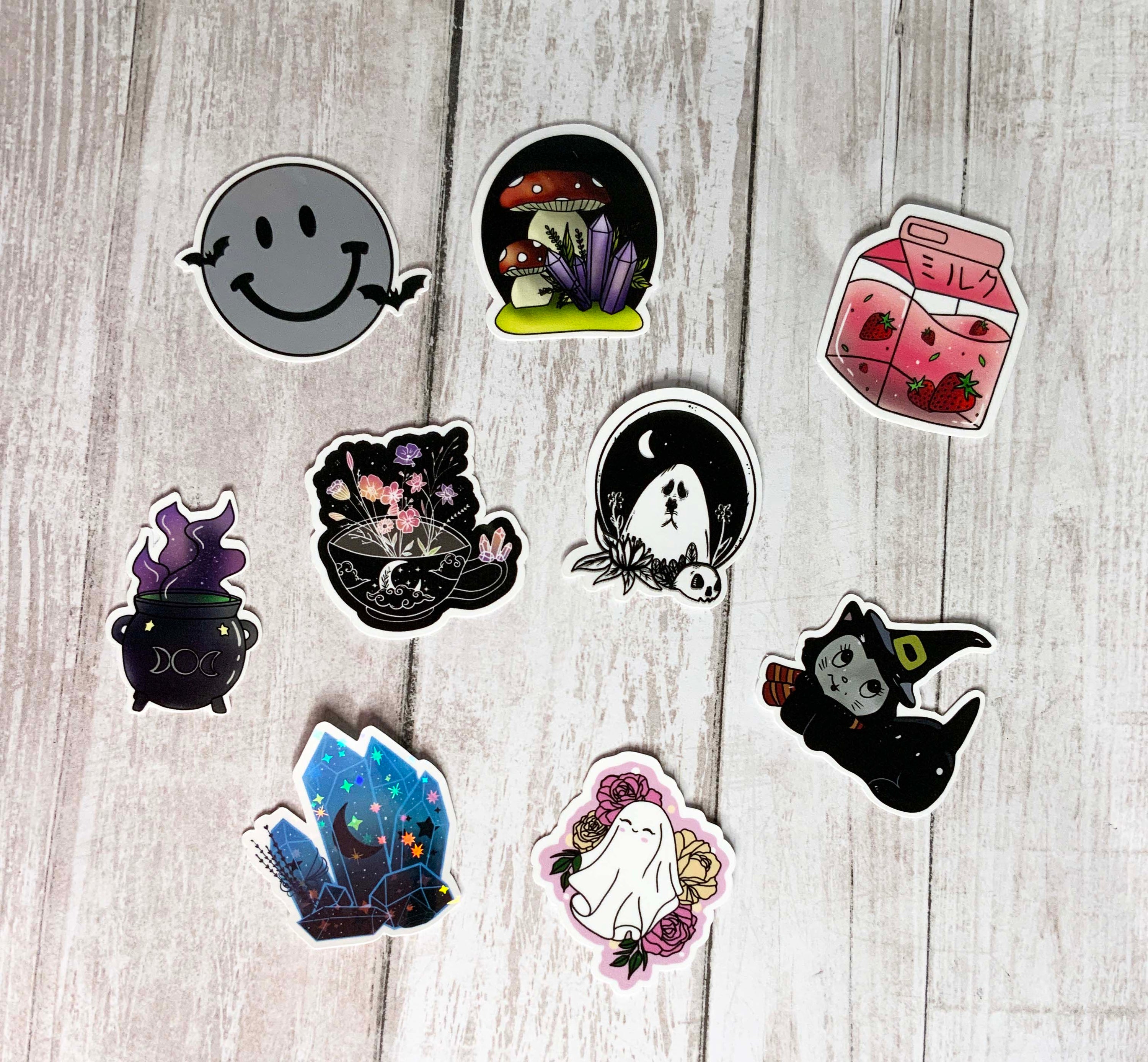 A colorful assortment of MINI Mystery Stickers featuring witchy, gothic, and cottagecore designs, displayed on a flat surface.