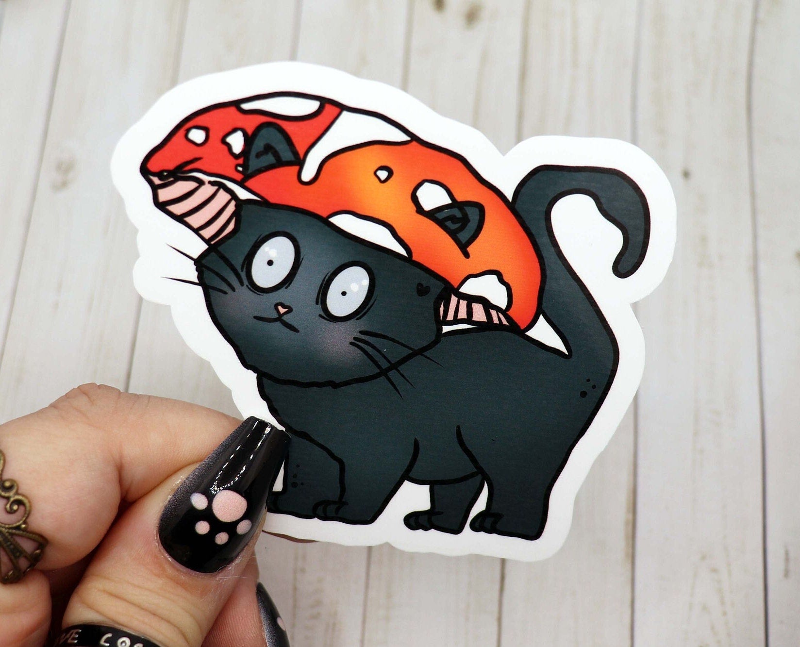 A cute vinyl sticker featuring a cat wearing a colorful mushroom hat, designed for personalizing various items.