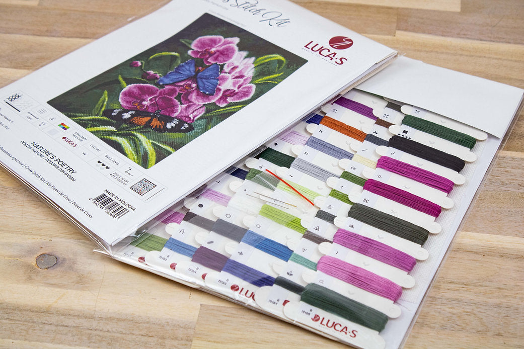 Nature's Poetry B7010L Counted Cross-Stitch Kit with Aida canvas, needle, and colorful threads displayed on a table.