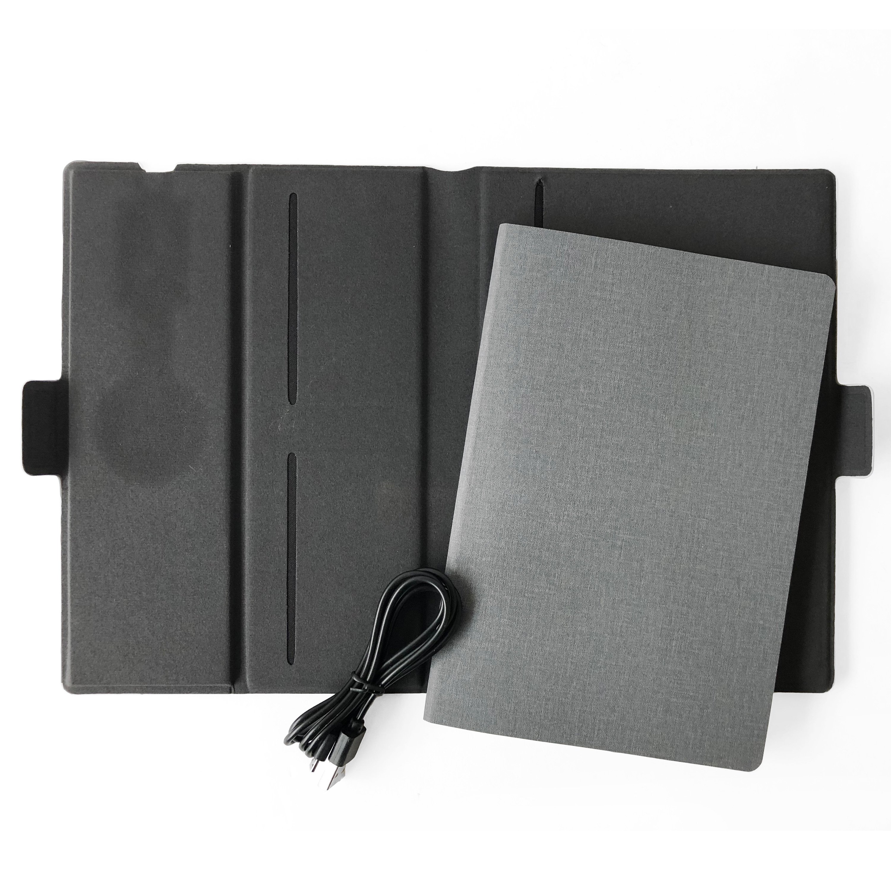 NICCI lightweight notebook with wireless charging pad for smartphones, featuring a removable A5 lined notebook and card slots.