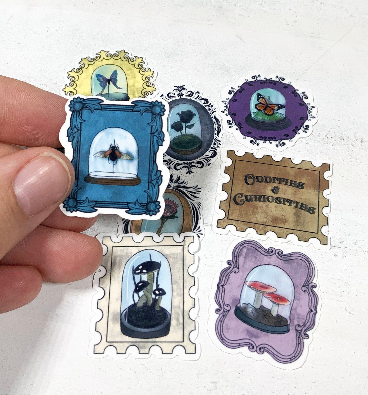 A collection of 9 unique oddity and curiosity stamp stickers, showcasing vibrant designs on high-quality matte vinyl.