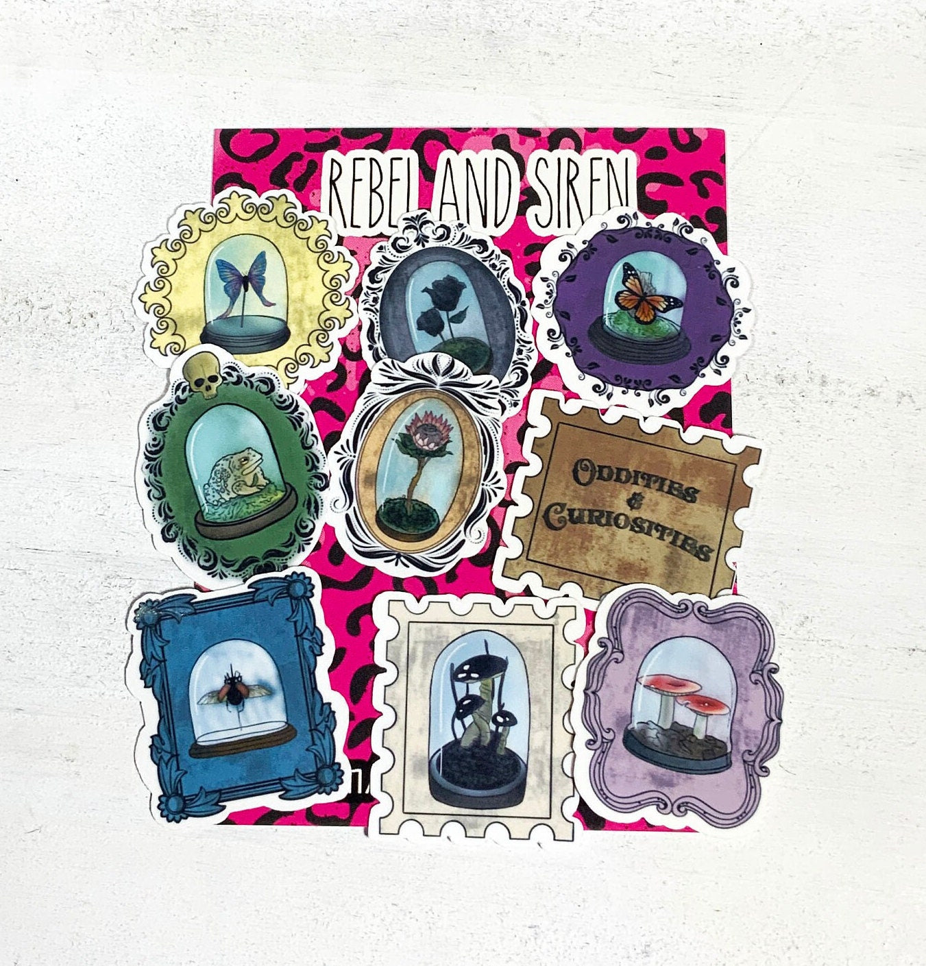 A collection of 9 unique oddity and curiosity stamp stickers, showcasing vibrant designs on high-quality matte vinyl.