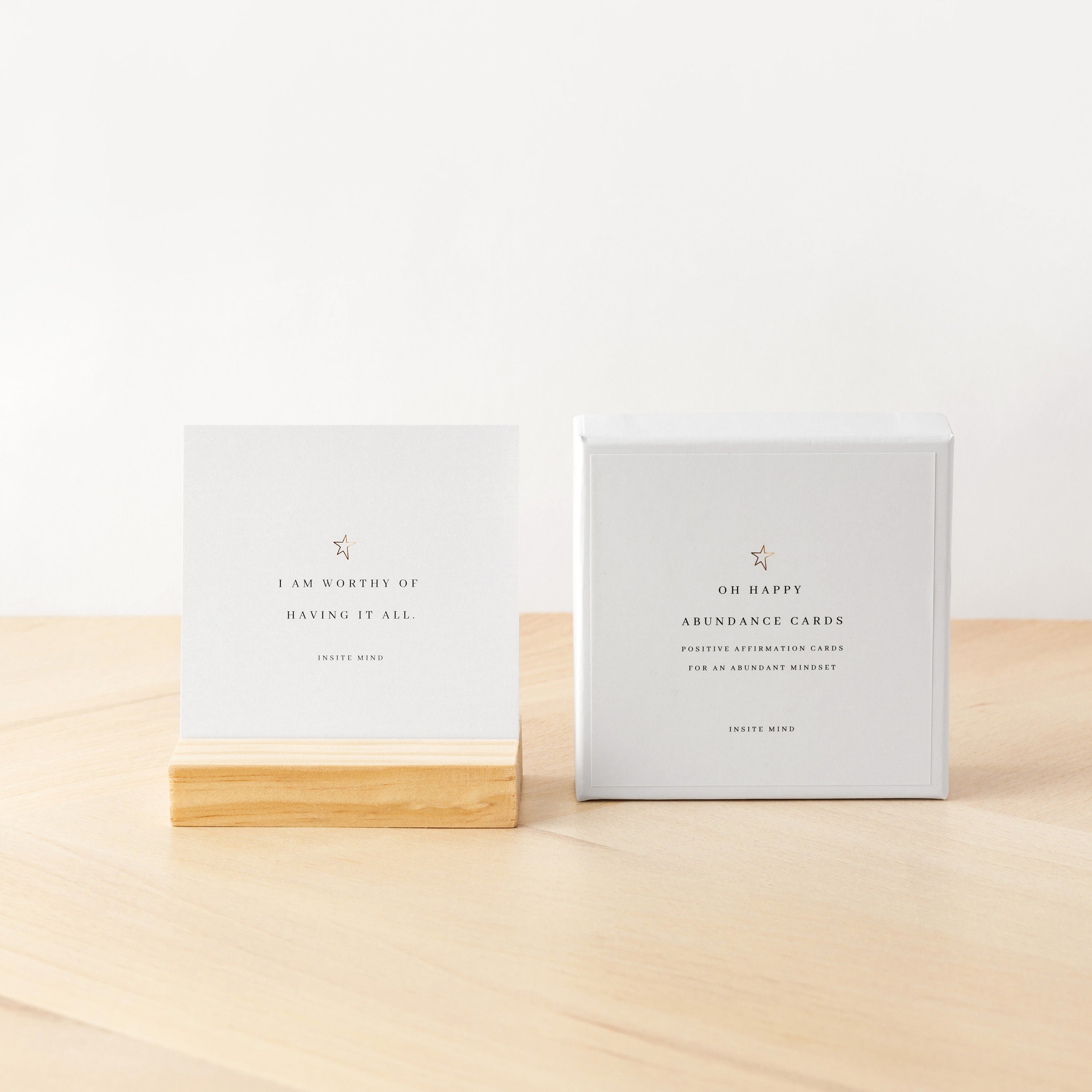 A beautifully designed set of Oh Happy Abundance Cards displayed on a stylish stand, showcasing vibrant affirmations for positivity and abundance.