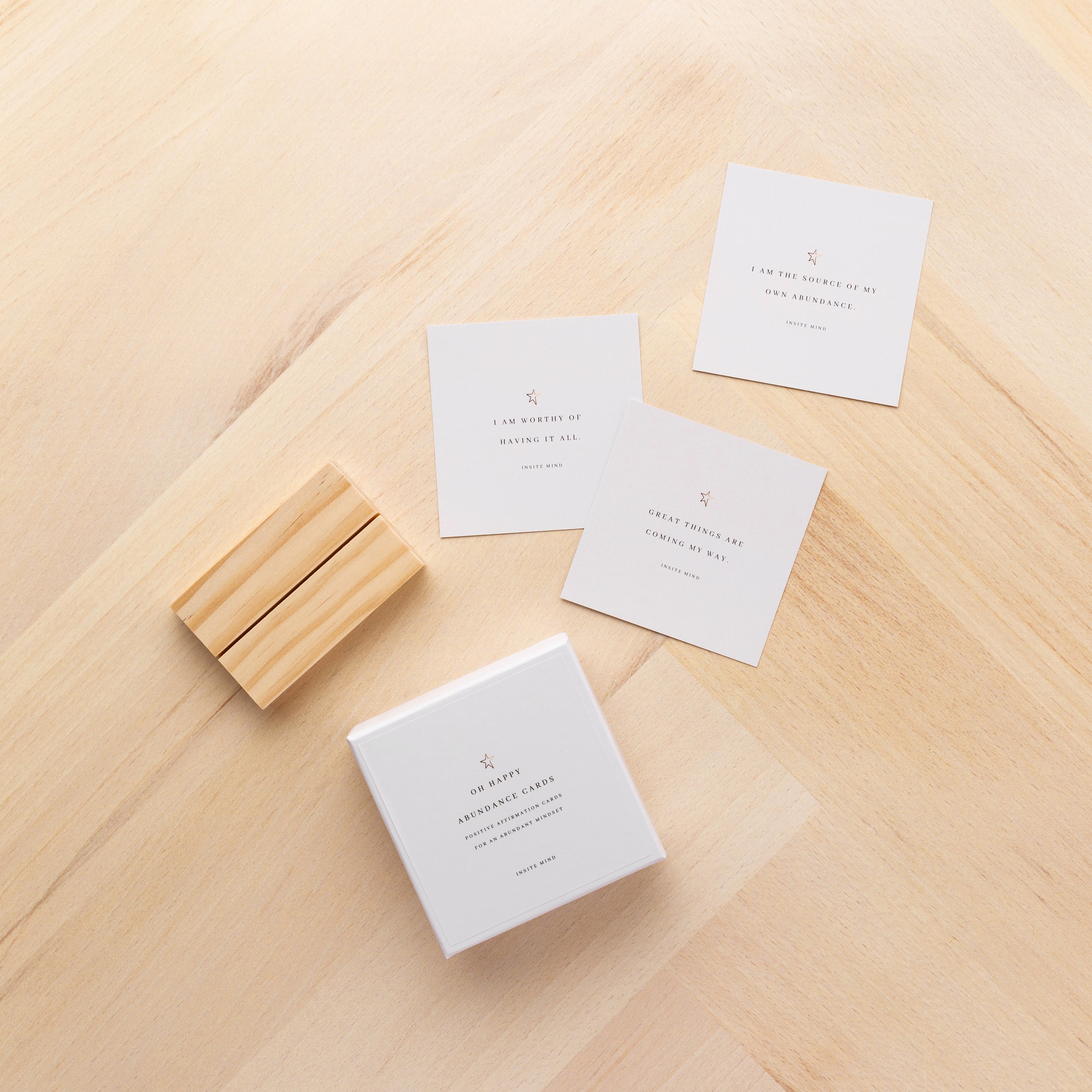 A beautifully designed set of Oh Happy Abundance Cards displayed on a stylish stand, showcasing vibrant affirmations for positivity and abundance.