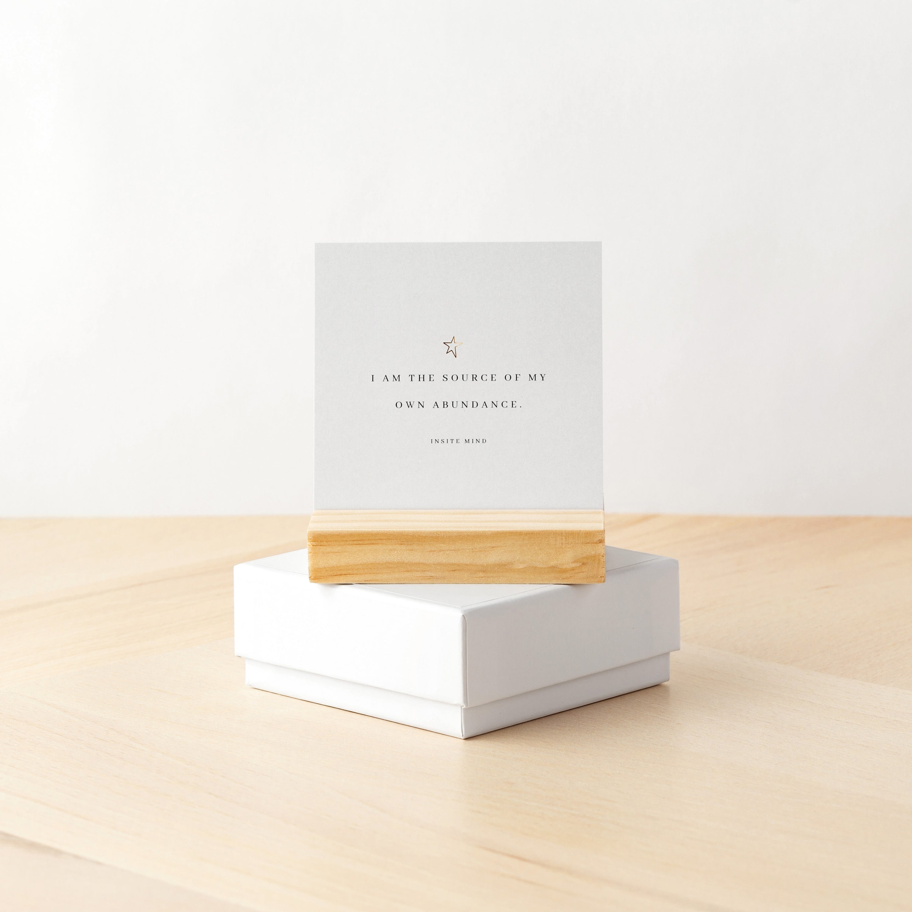 A beautifully designed set of Oh Happy Abundance Cards displayed on a stylish stand, showcasing vibrant affirmations for positivity and abundance.