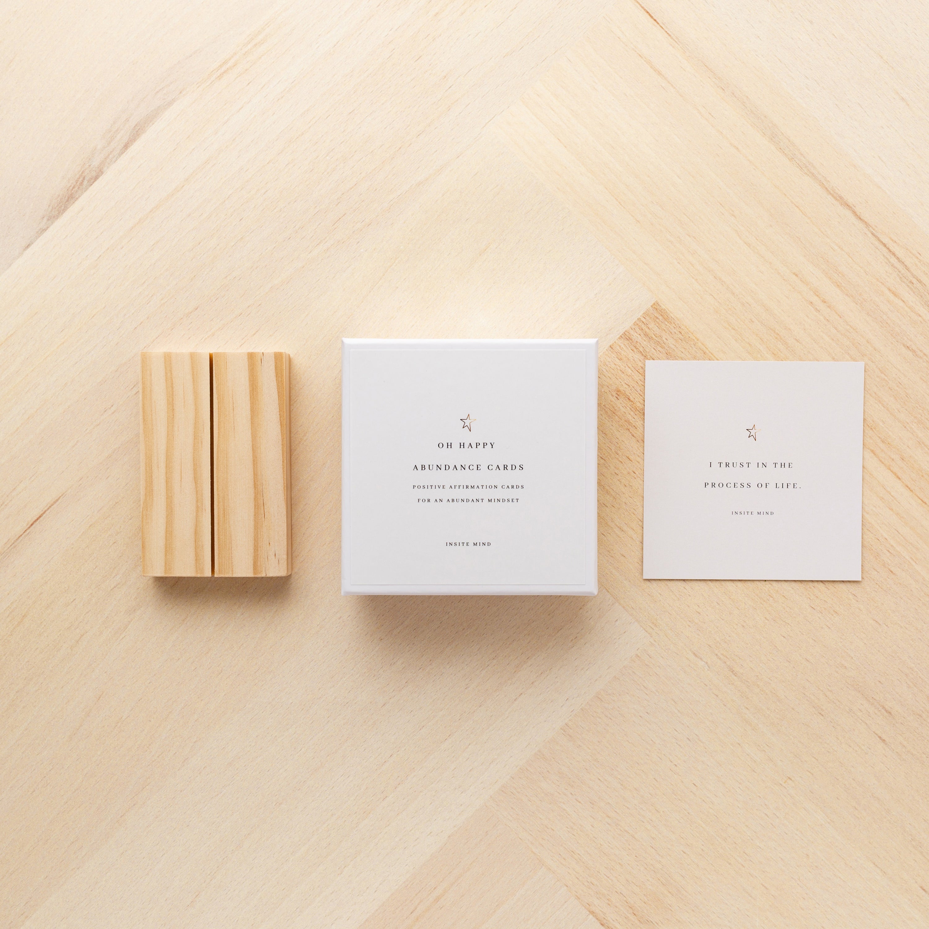 A beautifully designed set of Oh Happy Abundance Cards displayed on a stylish stand, showcasing vibrant affirmations for positivity and abundance.