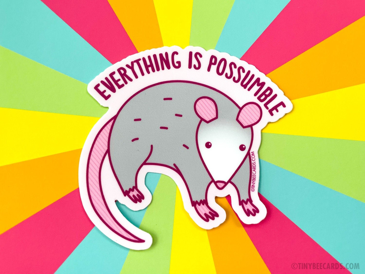 A cute opossum vinyl sticker with the text 'Everything is Possumble!' showcasing a whimsical design perfect for decoration.