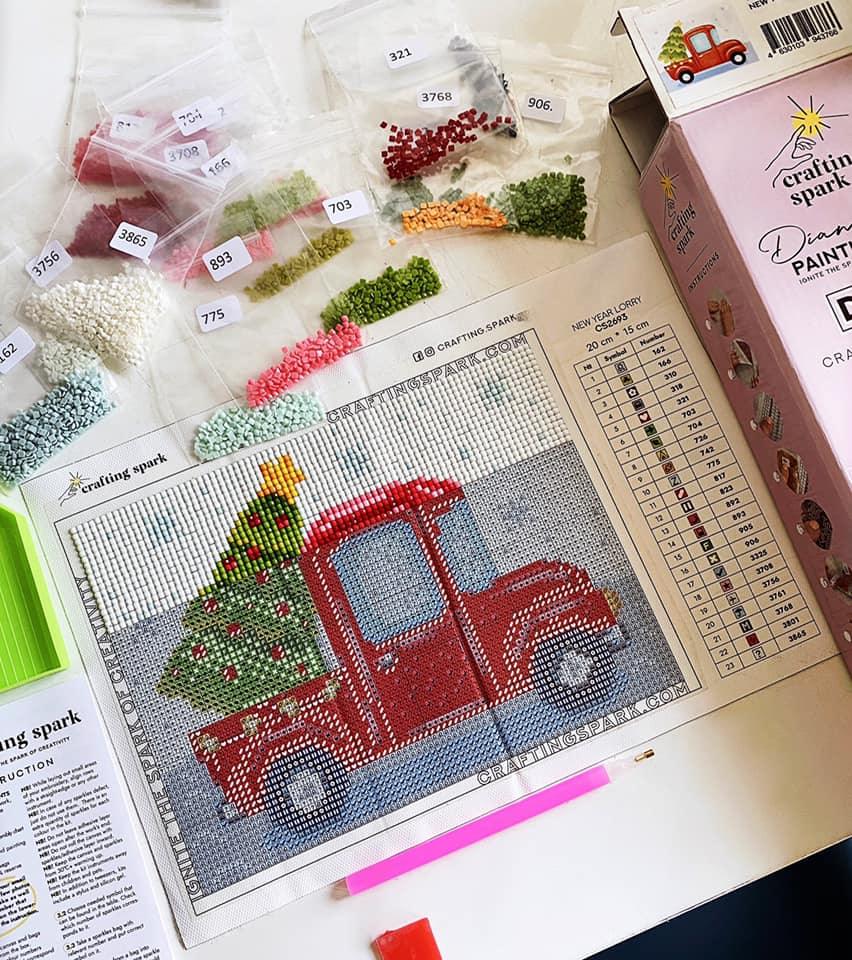 Panda CS303 Crafting Spark Diamond Painting Kit with tools and colorful acrylic diamonds displayed on a table.