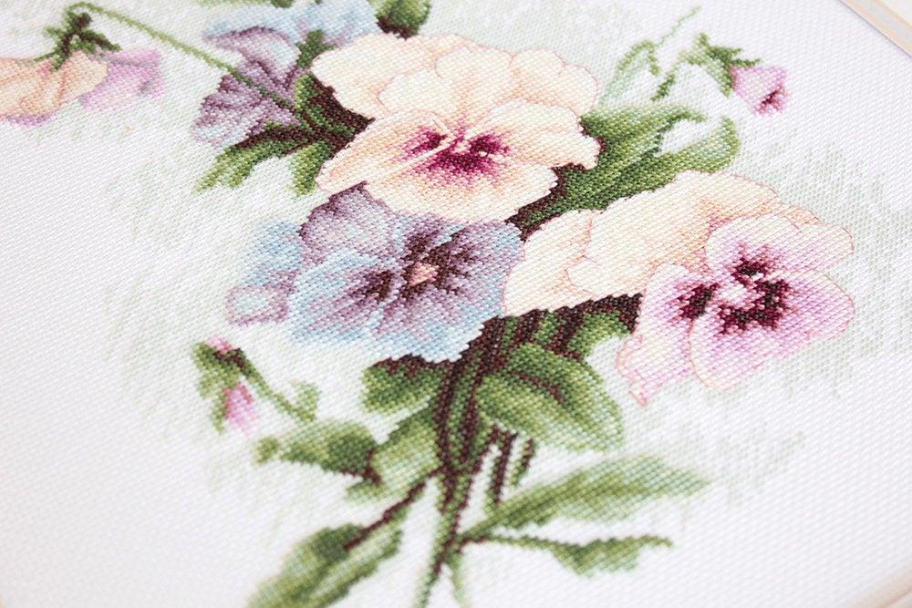 Pansies B2231L Counted Cross-Stitch Kit featuring colorful threads, Aida canvas, and needle, designed by Catharina Klein.