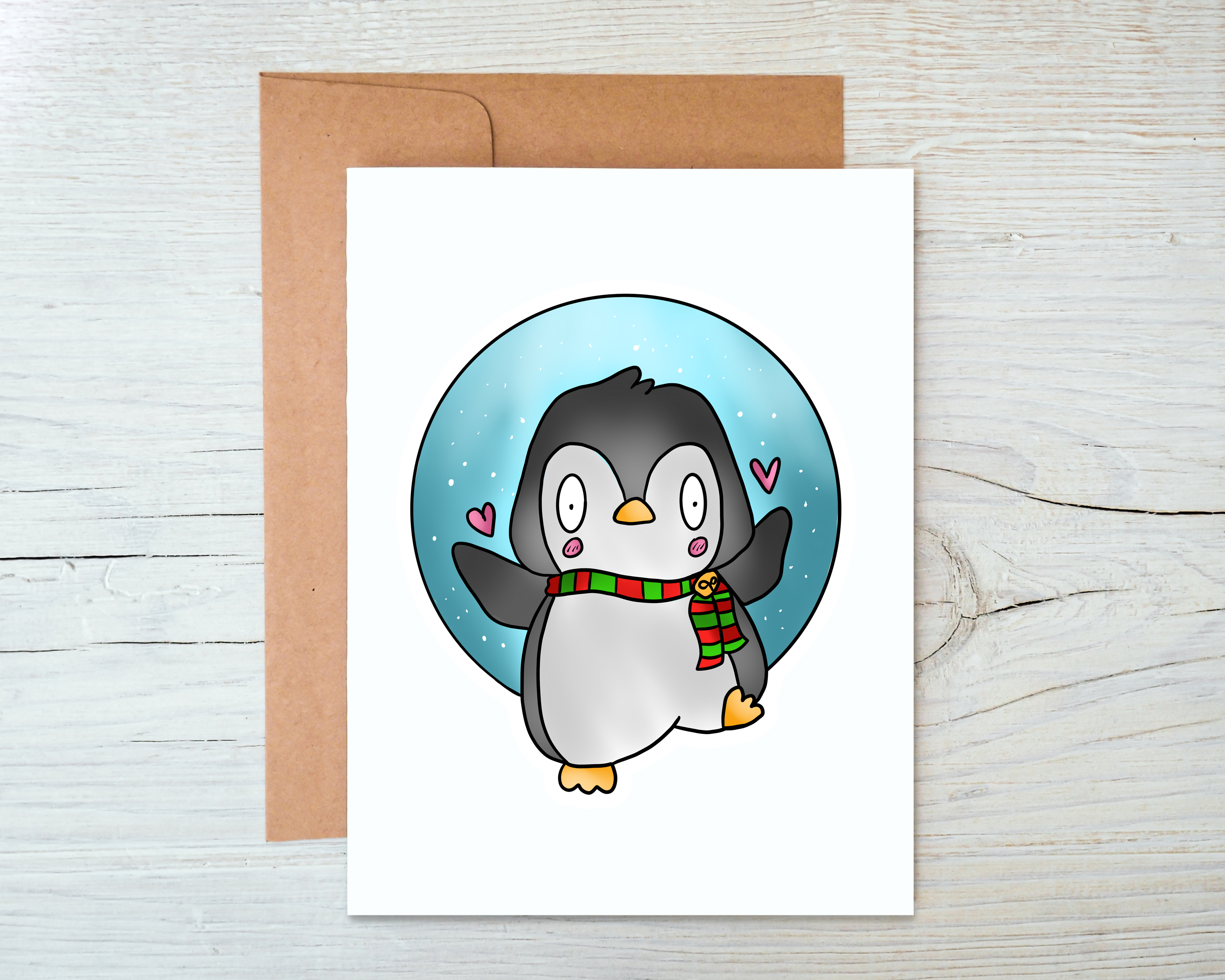 A festive Penguin Christmas Card featuring a cute penguin design, blank inside, accompanied by a kraft envelope.