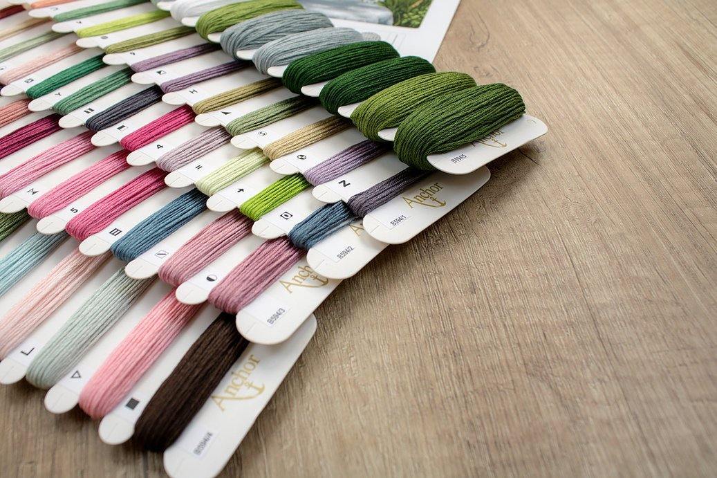 Counted cross stitch kit featuring blooming pink and white peonies by an open window, designed by Michail Satarov.