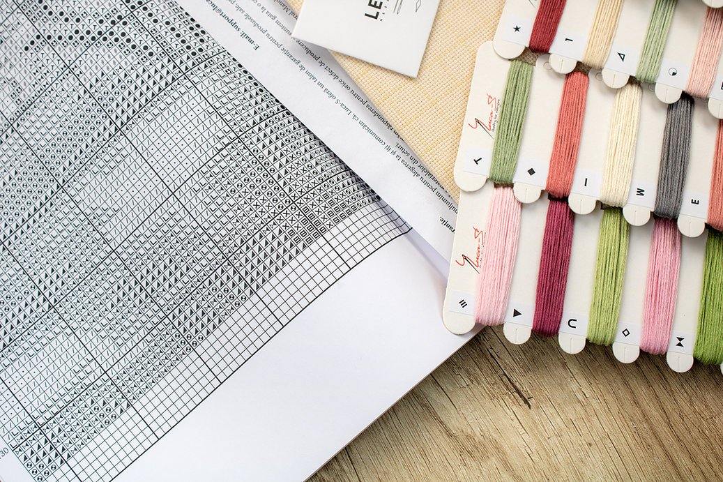 Counted cross stitch kit featuring blooming pink and white peonies by an open window, designed by Michail Satarov.