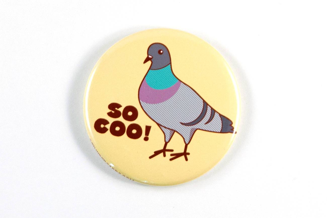 A 2.25-inch round magnet featuring a cute pigeon and the pun 'So Coo!' in vibrant colors.