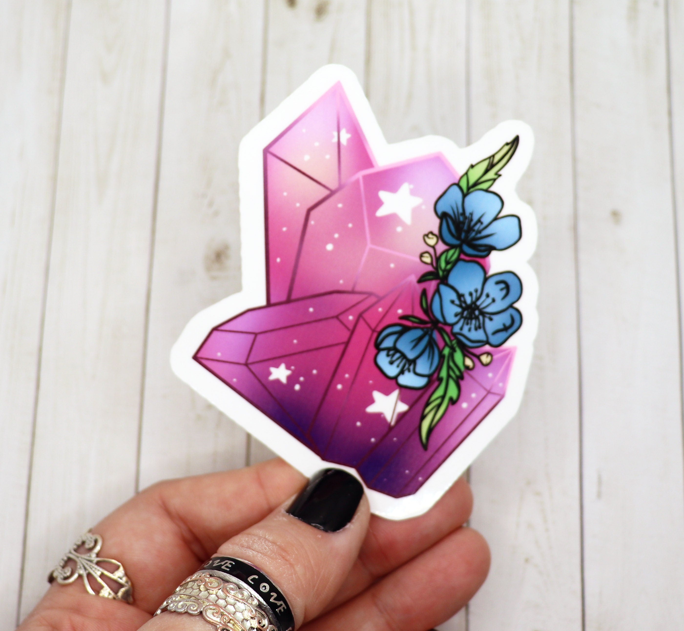 A vibrant pink crystal sticker featuring delicate flowers, perfect for personalizing various items.