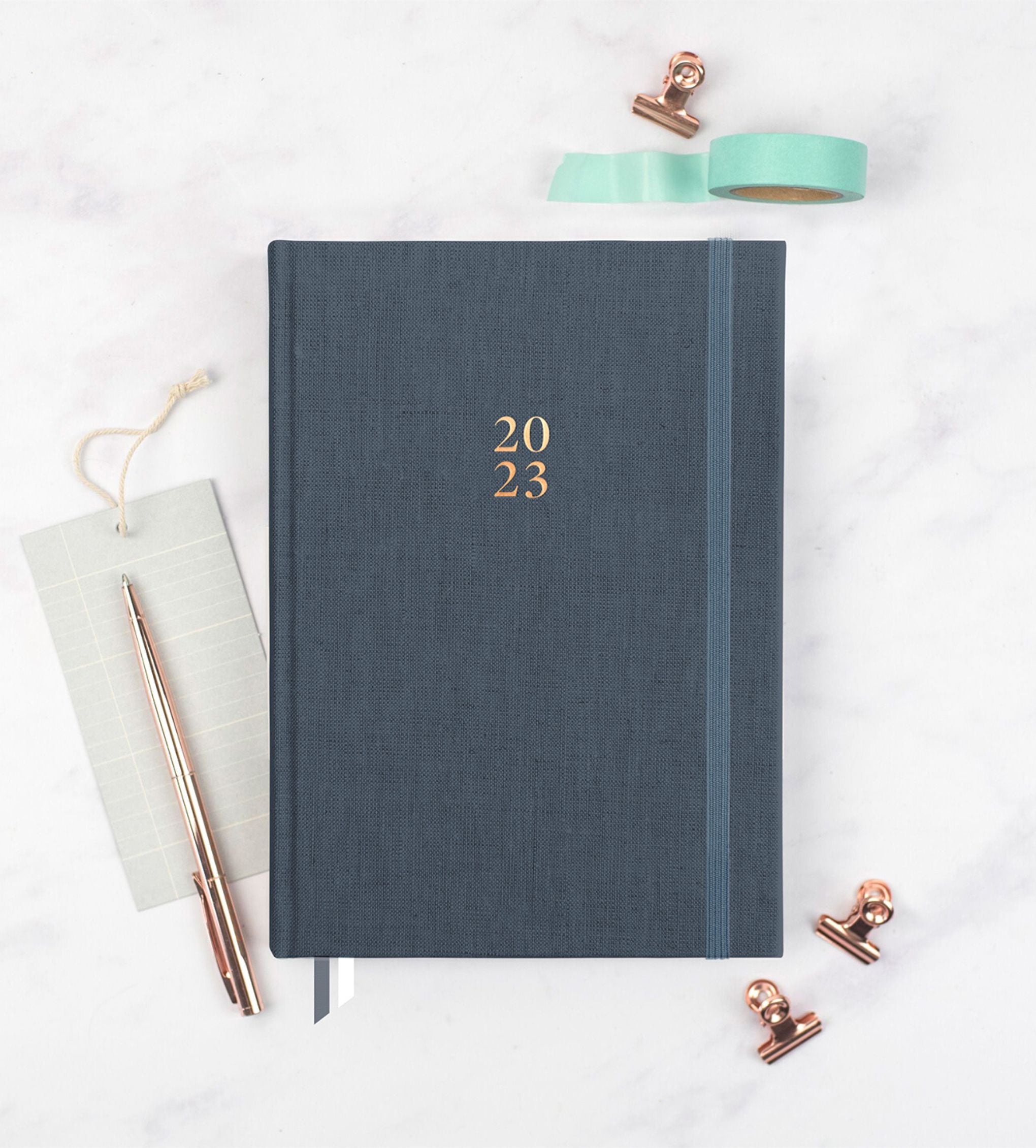 Ponderlily Weekly Planner 2023 in Midnight Blue with copper foil lettering, showcasing its elegant design and eco-friendly materials.