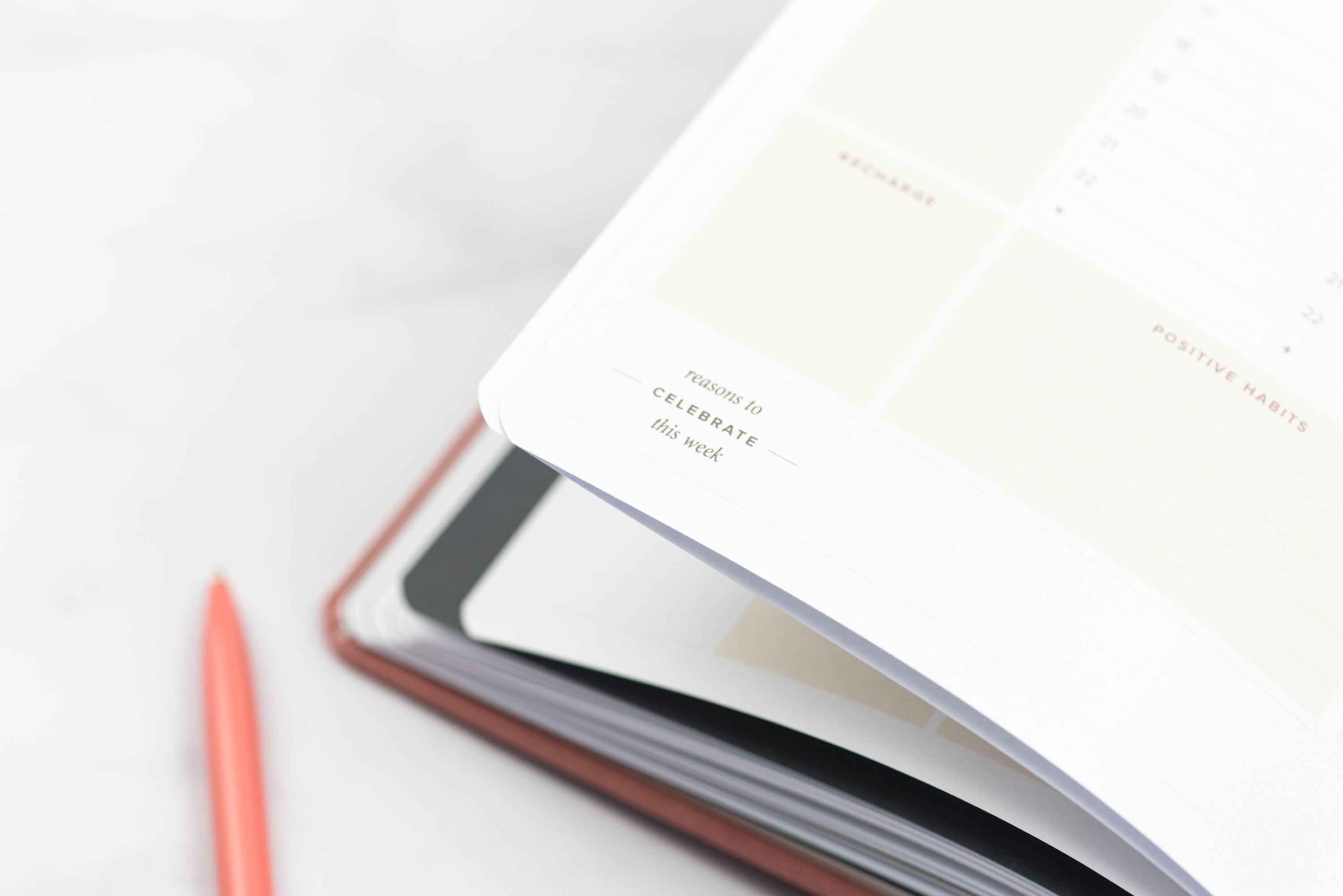 Ponderlily Weekly Planner 2023 in olive green with fabric cover, featuring inspirational quotes and organized sections for goals and notes.