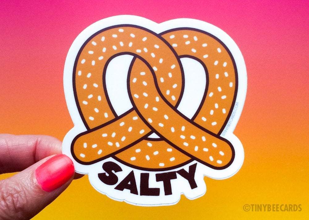 A cute vinyl sticker featuring a pretzel with salt and humorous text, perfect for decoration.