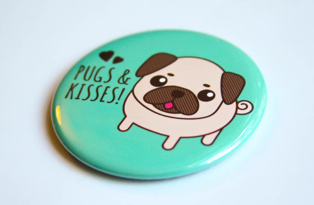 A round 2.25-inch button featuring a cute pug design with the text 'Pugs & Kisses!' available as a magnet, pin, or mirror.