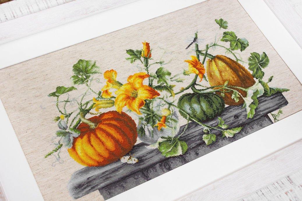Pumpkin B2303L Counted Cross-Stitch Kit with Aida canvas, colorful threads, and needle, showcasing autumn-themed design.