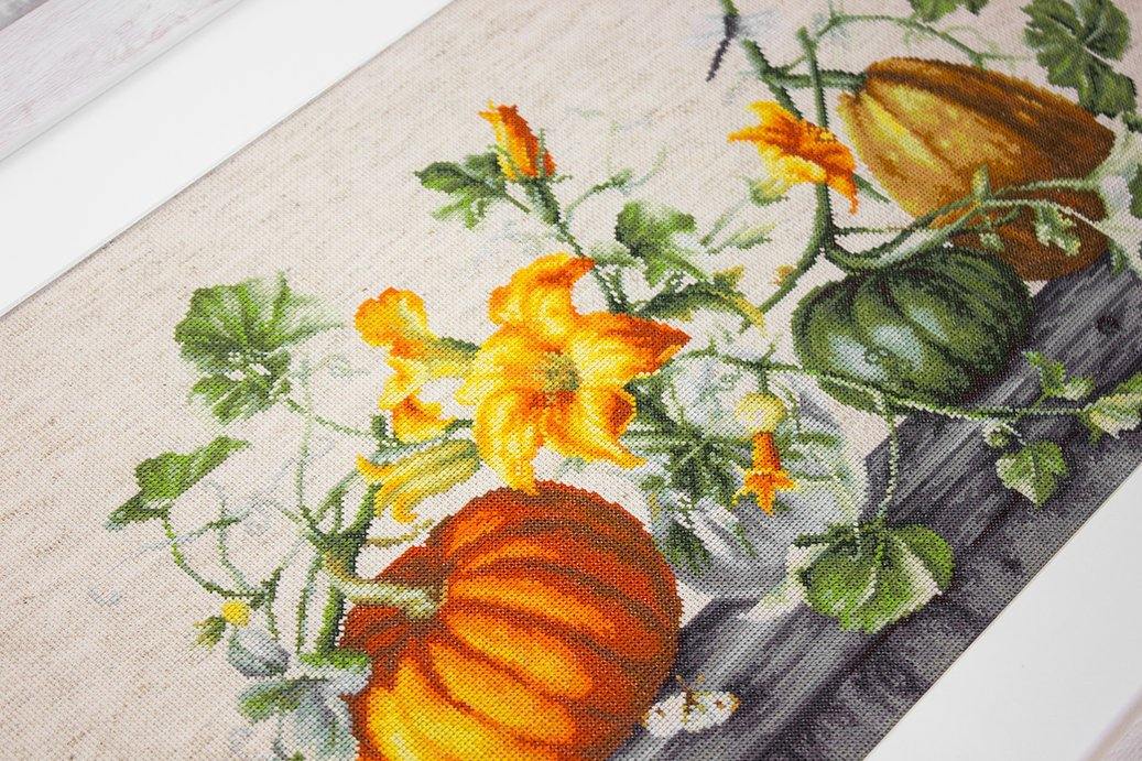 Pumpkin B2303L Counted Cross-Stitch Kit with Aida canvas, colorful threads, and needle, showcasing autumn-themed design.