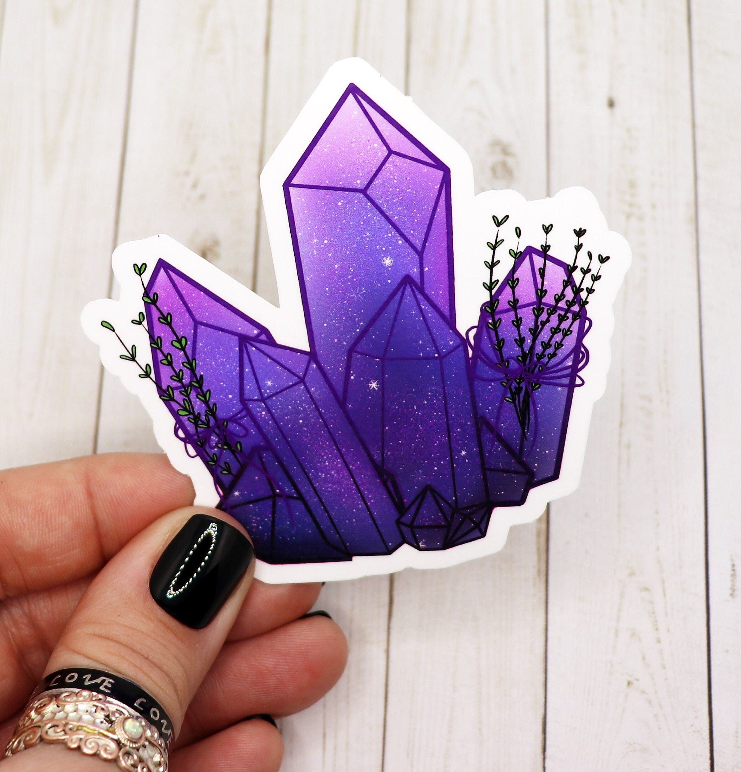 Purple aesthetic celestial crystal sticker on a white background, showcasing its vibrant colors and intricate design.