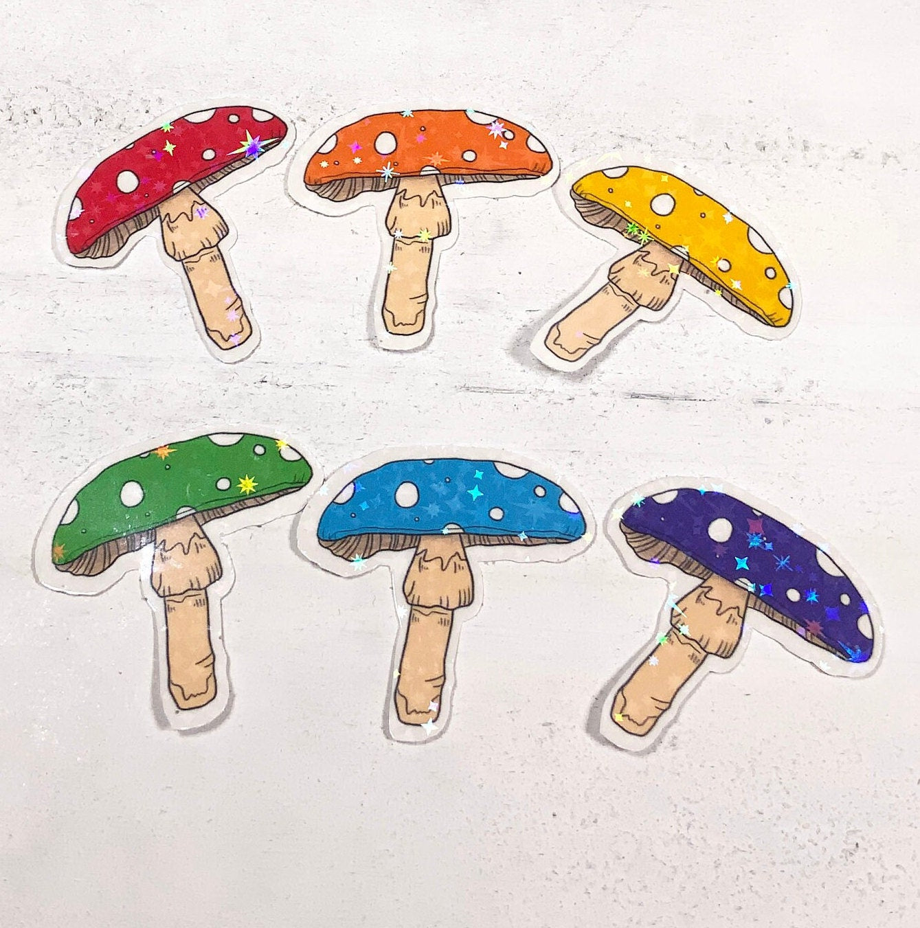 A vibrant Rainbow Mushroom Sticker Set featuring 6 star holo mushroom designs on high-quality matte vinyl.