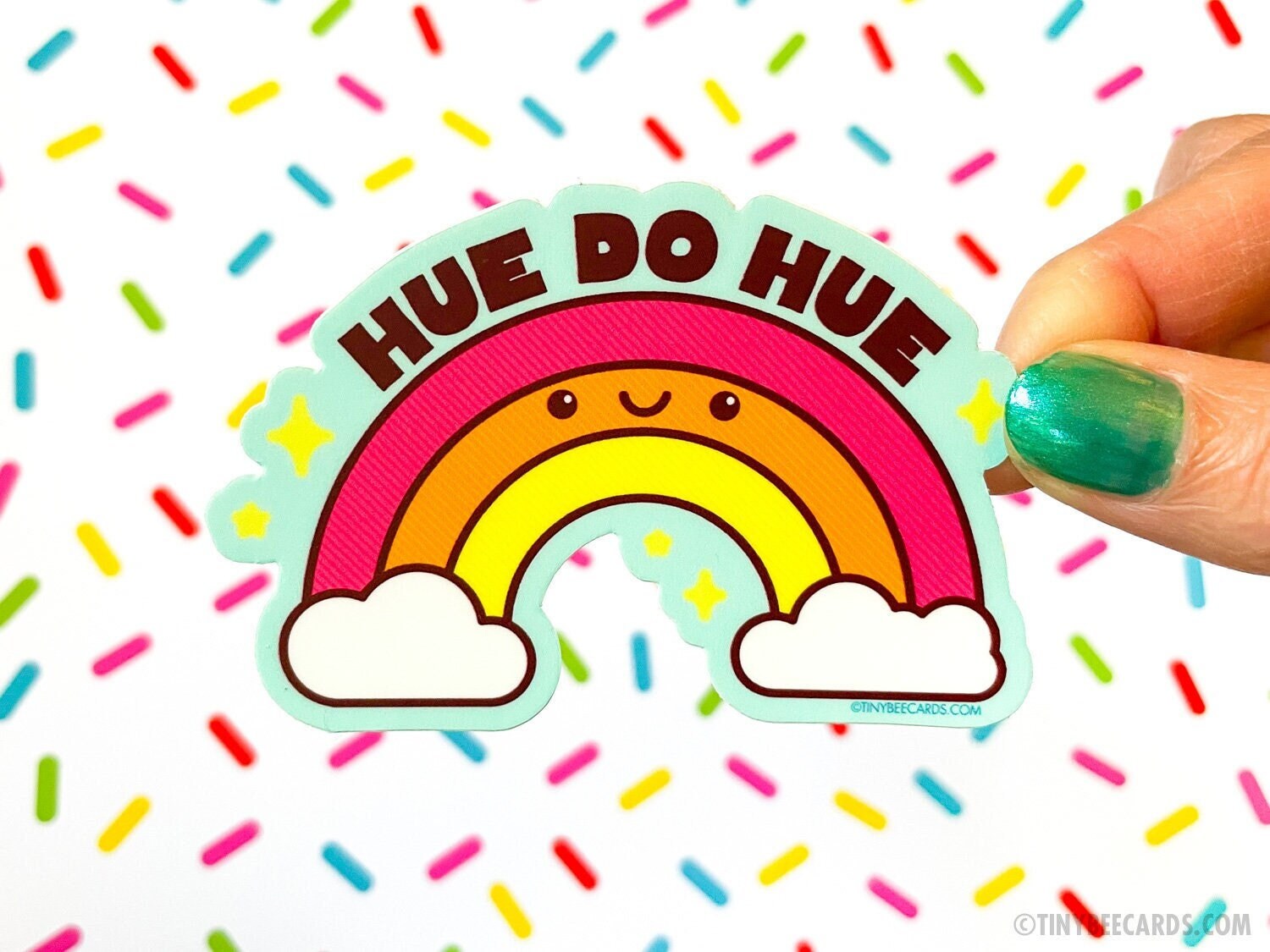 Colorful rainbow vinyl sticker with pun text 'Hue do hue!' on a sky blue background, perfect for personalizing items.