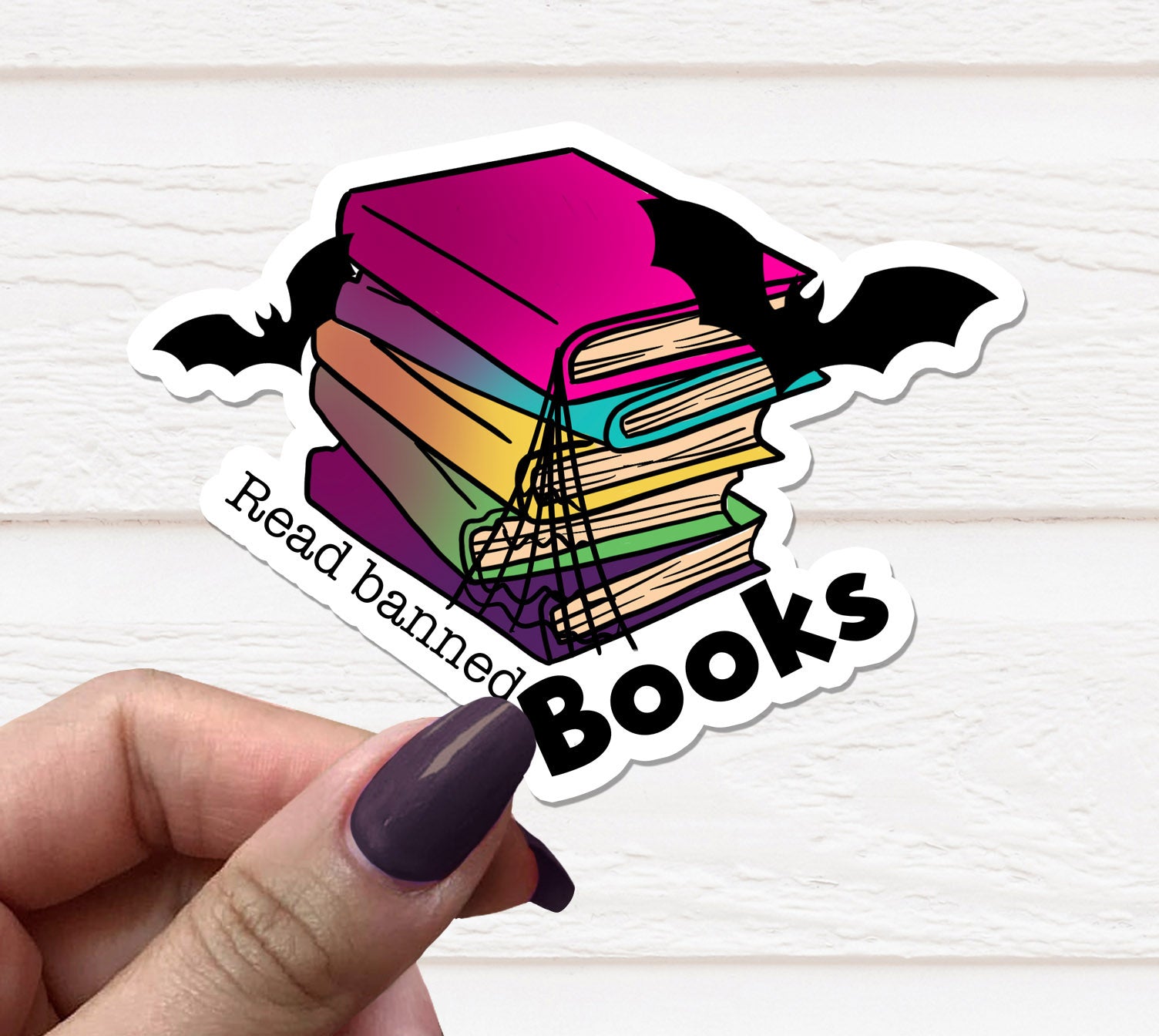 A vibrant Read Banned Books Sticker on a matte vinyl surface, showcasing its unique design and quality finish.