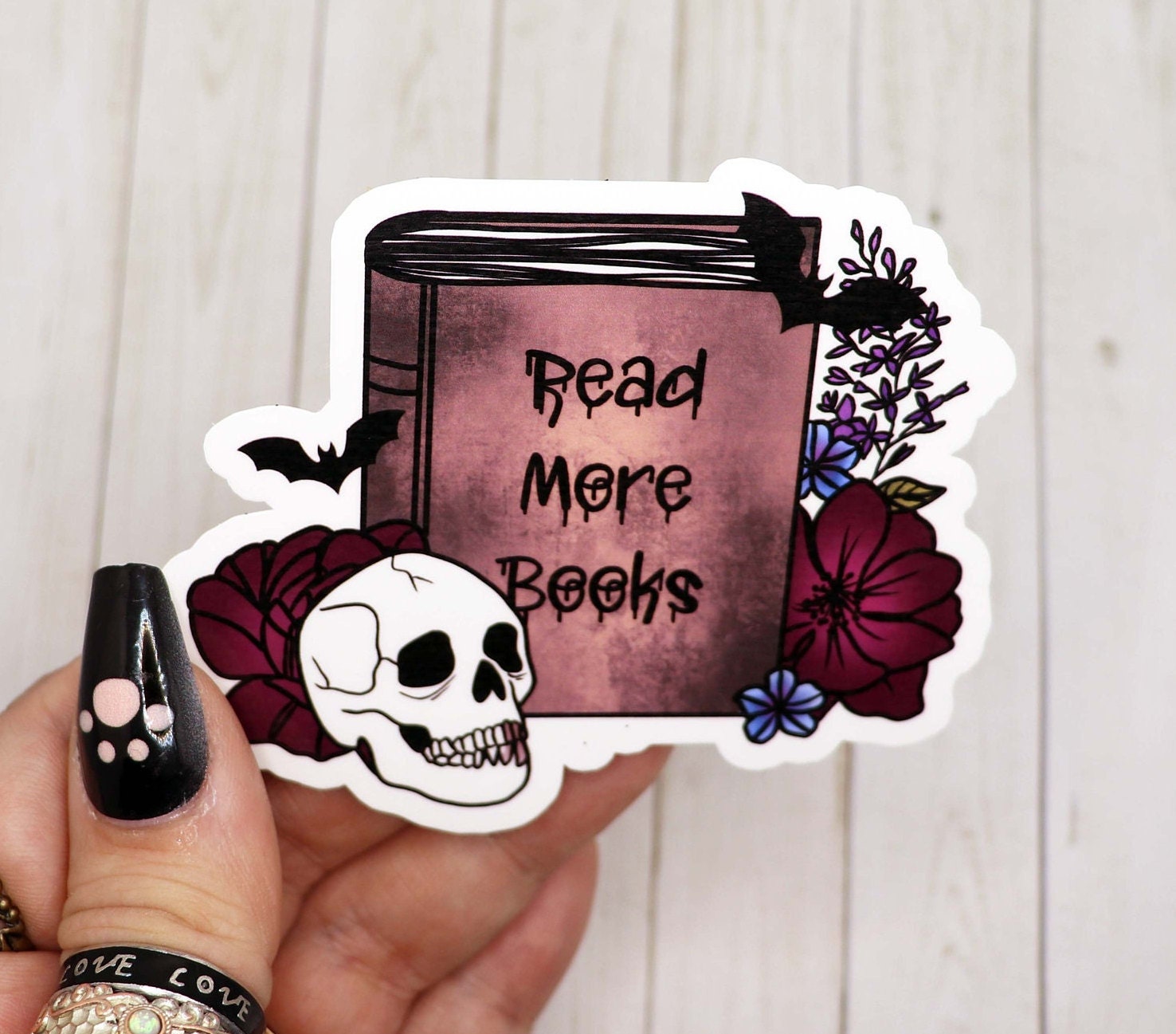 A stylish 3-inch vinyl sticker that says 'Read More Books' on a matte finish, perfect for personalizing items.