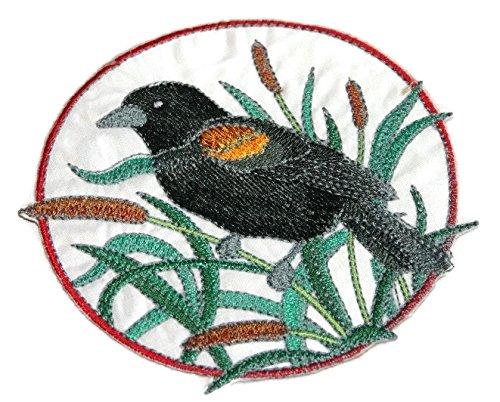 Embroidered patch featuring a red-winged blackbird surrounded by cattails, designed for iron-on or sewing application.