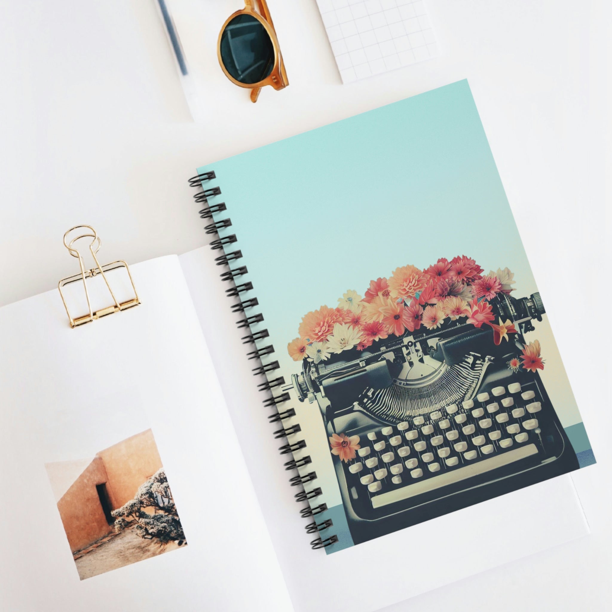 A Retro Typewriter Spiral Notebook featuring a vintage typewriter design on the front cover and a dark grey back cover, ideal for note-taking.