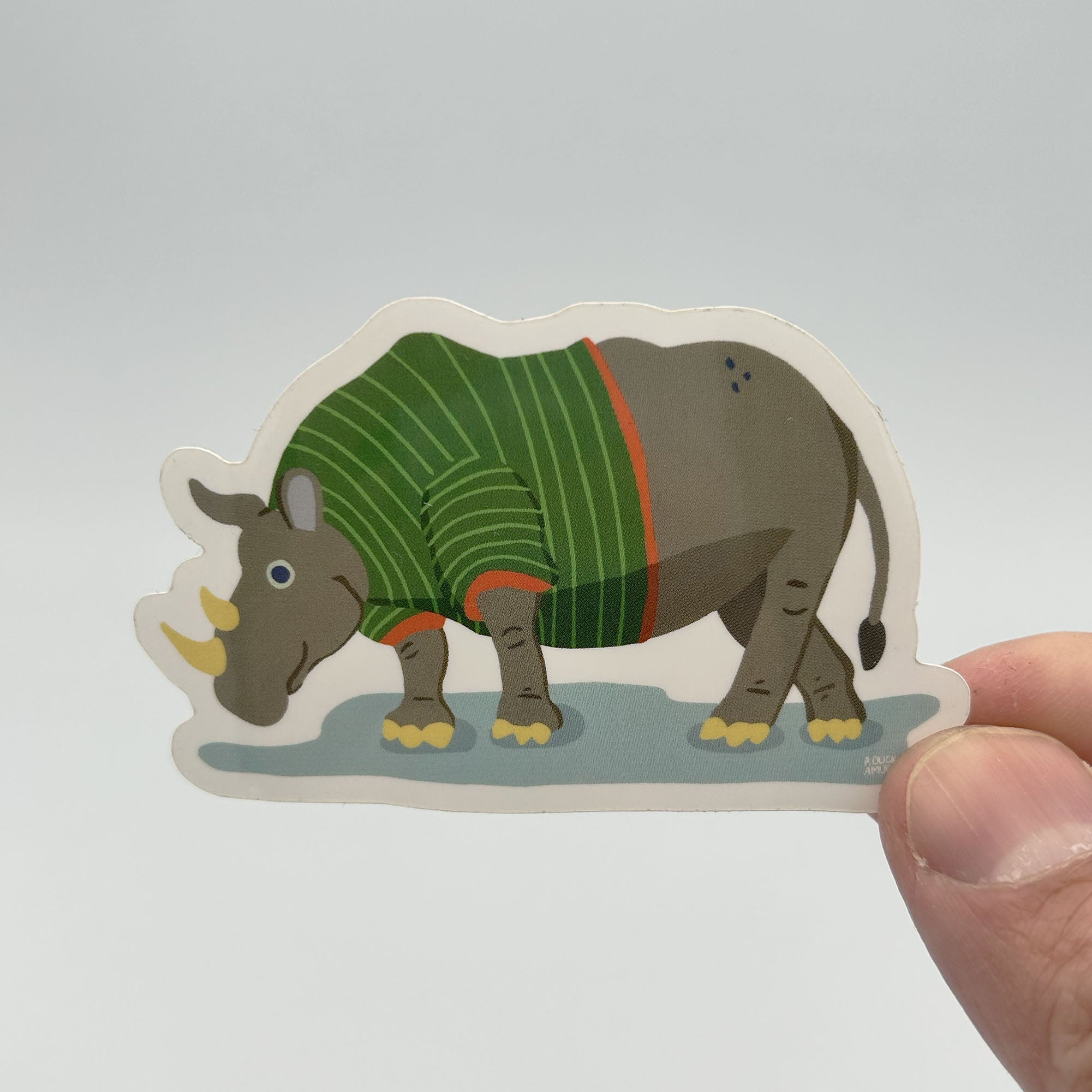 A colorful vinyl sticker featuring a rhinoceros wearing a t-shirt, ideal for personalizing items.